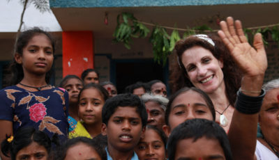 Lori Barra with local youth on a donor trip in Nepal