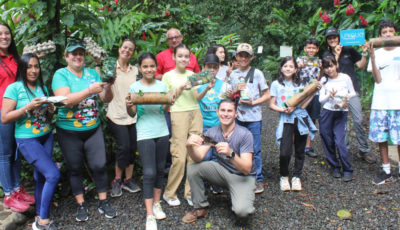 Group of students from El Cruce School in Costa Rica holding wildlife enrichment toys at Projecto Asis Wildlife Rescue Centre.