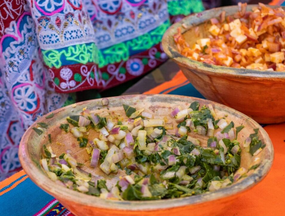 bowls with traditional peruvian cusine and traditional fabric in the background in Arequipa, Peru.
