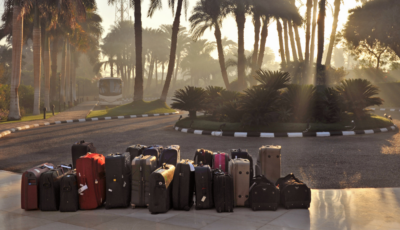 Pile of suitcases outside an airport