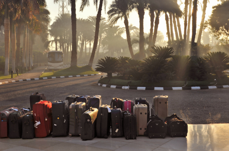 Pile of suitcases outside an airport