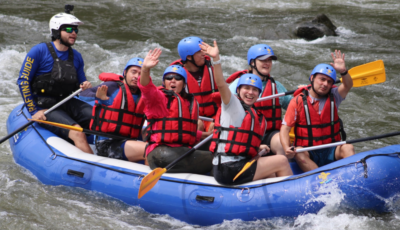 Group of people white water rafting