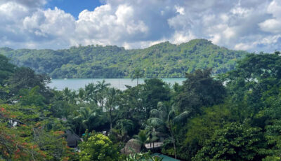 Panama: A view over rooftops, mountains, and the ocean in Portobelo, Panama.