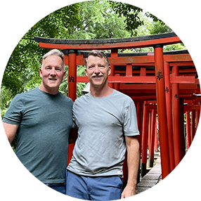 Travelers in front of Torii gates in Japan.