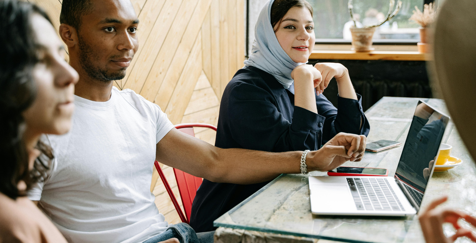 Co-workers sitting at a desk with a laptop