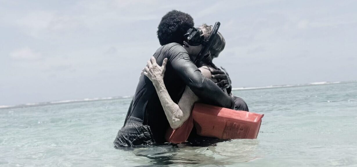 Mom hugging guide after snorkeling for the first time in Belize.