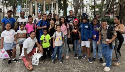 children and their families gather for a group photo in a plaza in Panama City.