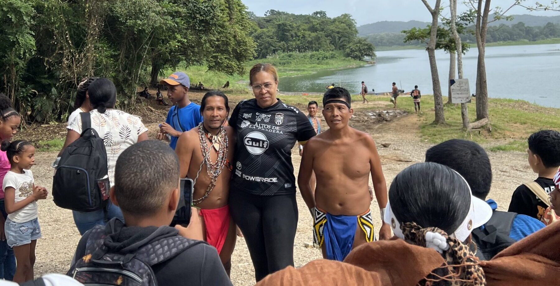 a woman from Panama City and two members of the Emberá community stand together for a photo in the rainforest.