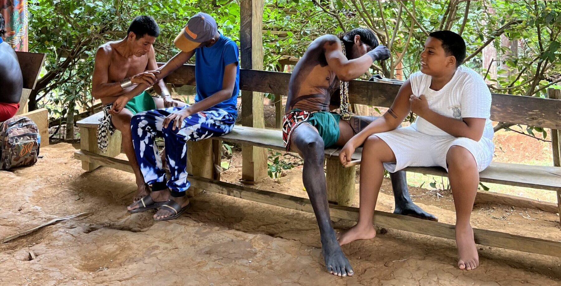 a moment of cultural exchange between students from Panama City and members of the Emberá community.