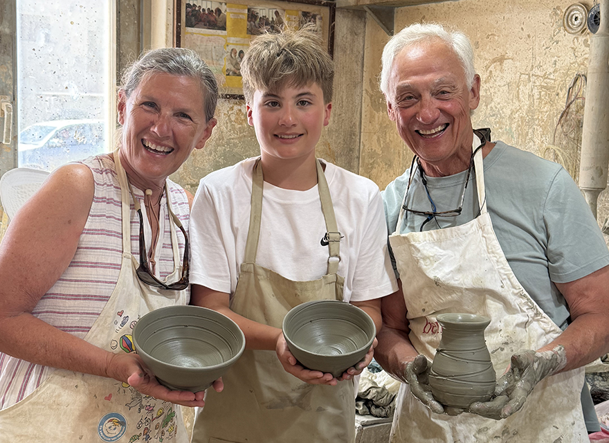 grandparents and grandchild making pottery in Greece